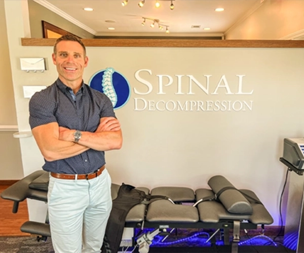 Chiropractor Greer SC Geoffrey Abrams In Front Of Decompression Machine