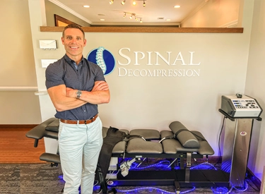 Chiropractor Greer SC Geoffrey Abrams In Front Of Decompression Machine