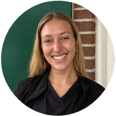 Bronwyn smiling while wearing black scrubs